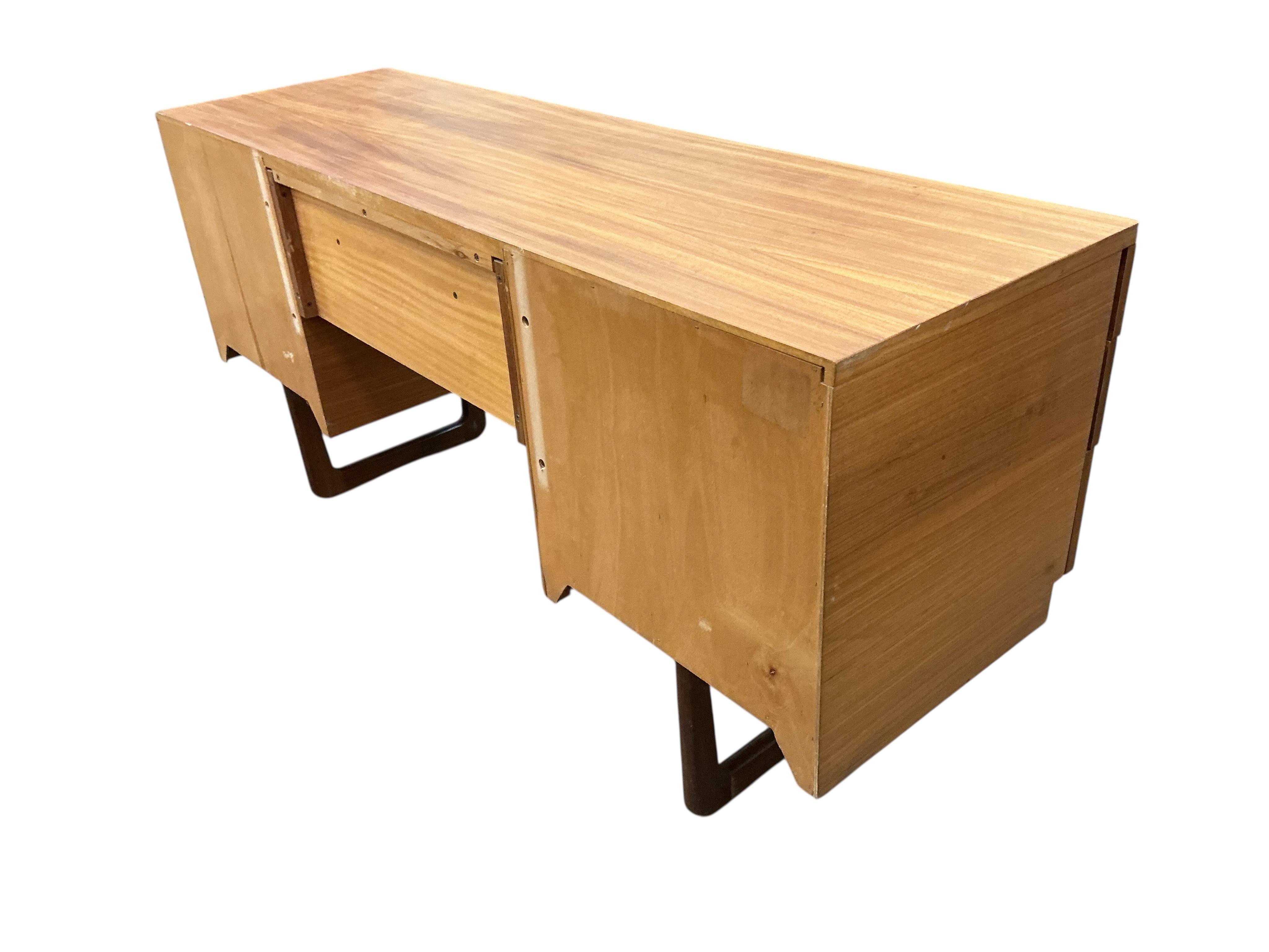 A mid century Uniflex teak kneehole dressing table, width 152cm, depth 46cm, height 71cm